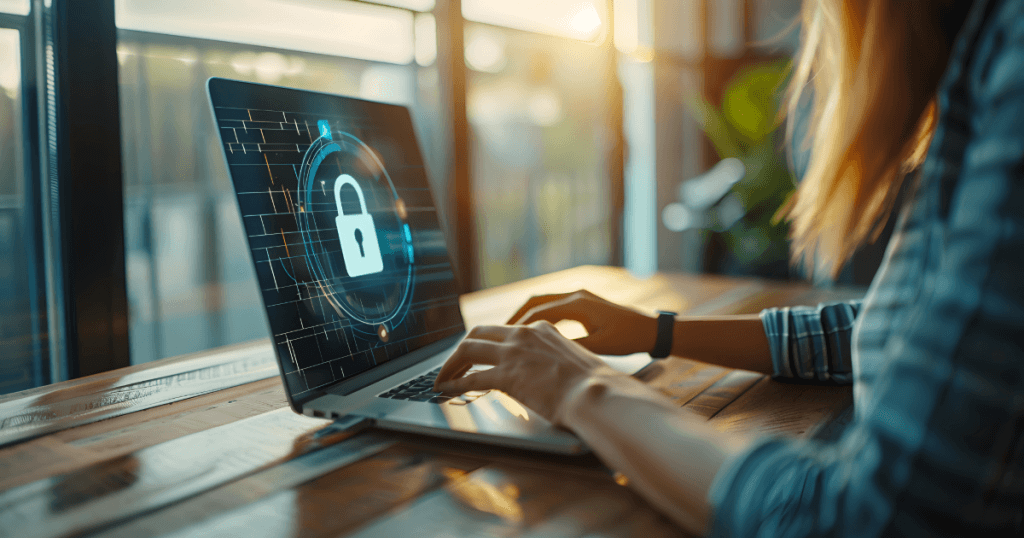 An image of a woman typing on a laptop with data and a padlock on the screen.